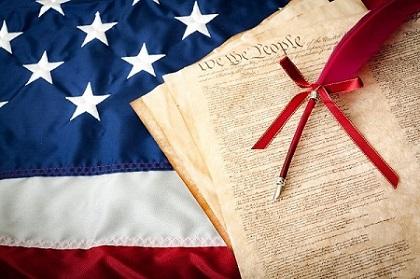 The American Flag & the U. S. Declaration of Independence & a red feather pen