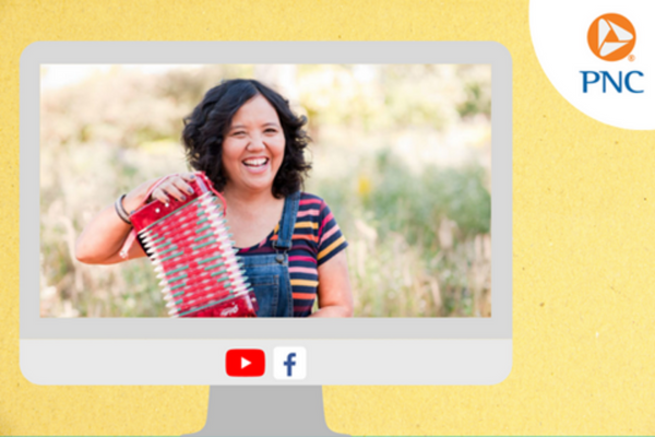 A image of a woman with holding an accordion in a field appears on a computer monitor