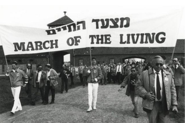 people with a banner marching in parade form
